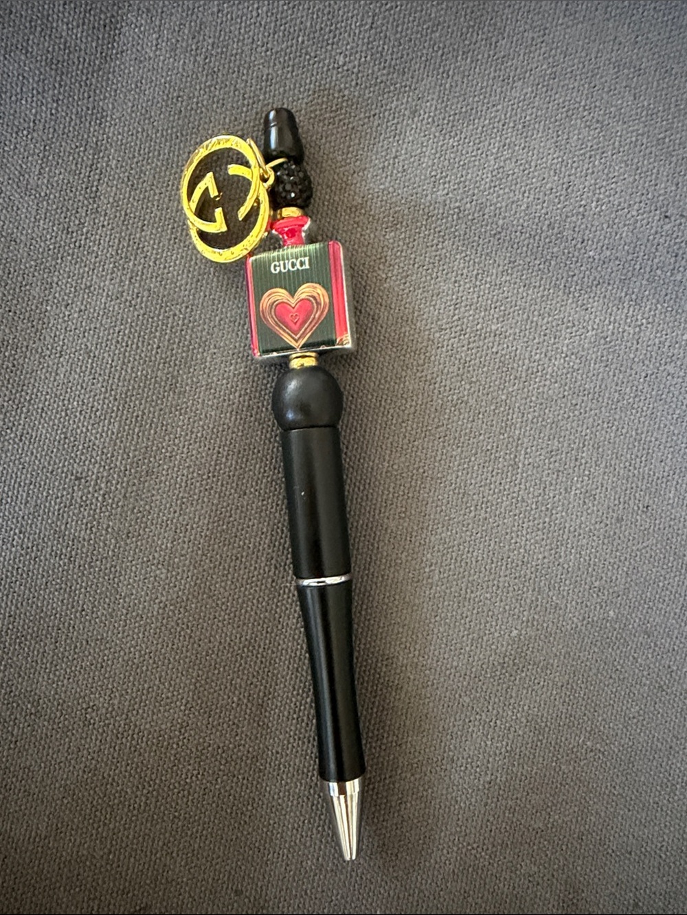 Handcrafted stylish pen with golden charm